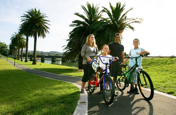 Teneti family biking on walkway